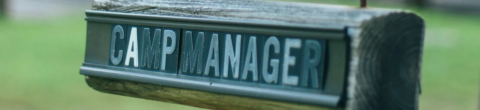 Wooden sign reading Camp Manager